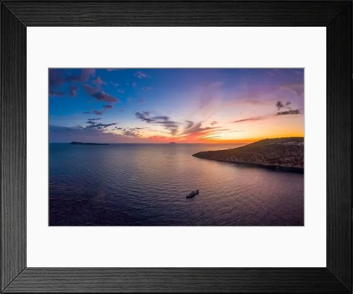 Framed Print : Aerial drone shot of boat drifting in Adriatic sea with sunset burning sky on Komiza over Vis Island in Croatia Summer Framed Print : Aerial drone shot of boat drifting in Adriatic sea with sunset burning sky on Komiza over Vis Island in Croatia Summer