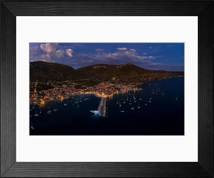 Framed Print : Aerial drone shot of Komiza town port in night with city light on Vis Island in Croatia summer dusk Framed Print : Aerial drone shot of Komiza town port in night with city light on Vis Island in Croatia summer dusk