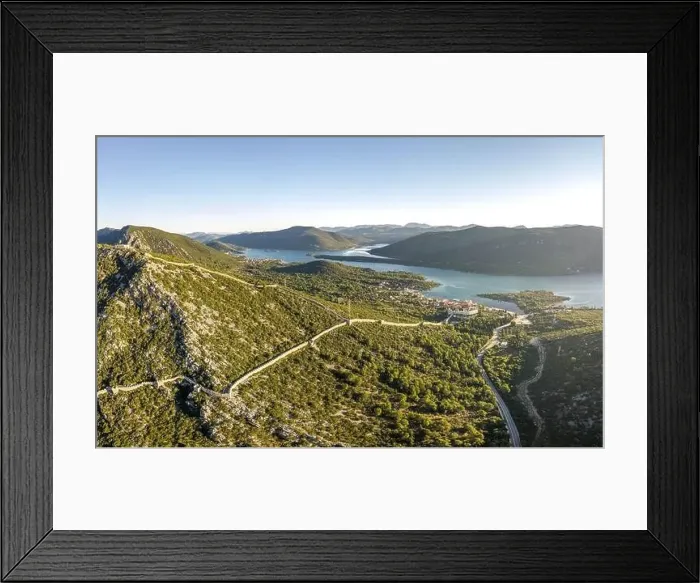 Framed Print : Aerial drone shot of City Wall of Ston over hill to Mali Ston in Croatia summer morning sunrise Framed Print : Aerial drone shot of City Wall of Ston over hill to Mali Ston in Croatia summer morning sunrise