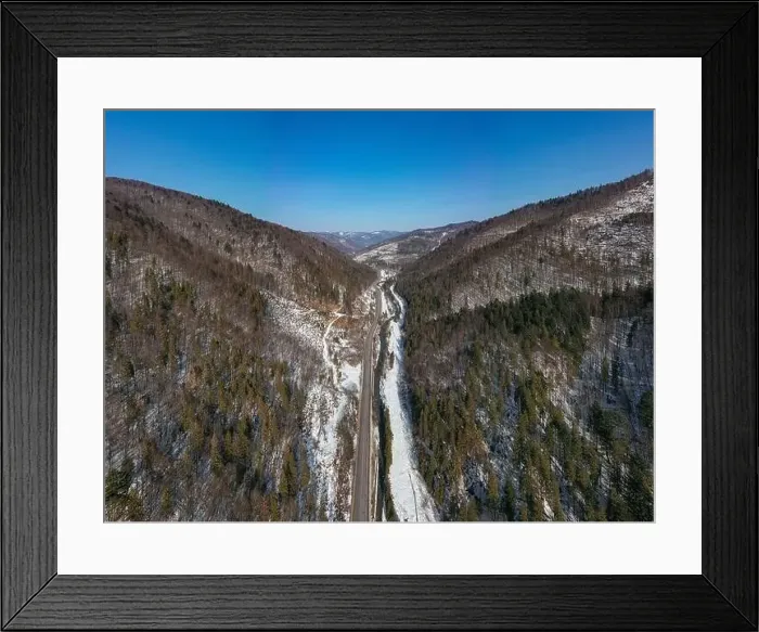 Framed Print : Aerial view on mountain road from drone in winter Framed Print : Aerial view on mountain road from drone in winter