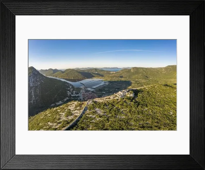 Framed Print : Aerial drone shot of Fortress of City of Ston on top of hill with view of Salt Pans in Croatia sunrise Framed Print : Aerial drone shot of Fortress of City of Ston on top of hill with view of Salt Pans in Croatia sunrise