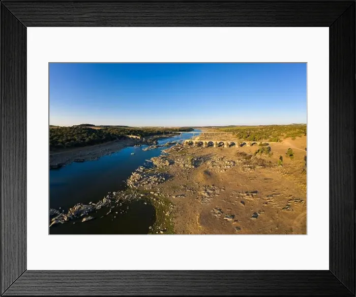Framed Print : Destroyed abandoned Ajuda bridge drone aerial view, crossing the Guadiana river between Spain and Portugal Framed Print : Destroyed abandoned Ajuda bridge drone aerial view, crossing the Guadiana river between Spain and Portugal