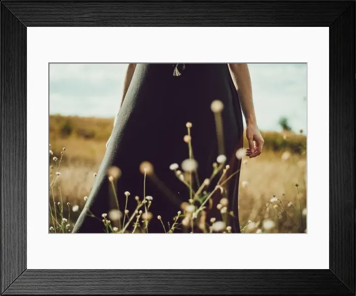 Framed Print : Mid section portrait boho style dress young woman standing in the grass and wildflowers connecting with nature Framed Print : Mid section portrait boho style dress young woman standing in the grass and wildflowers connecting with nature