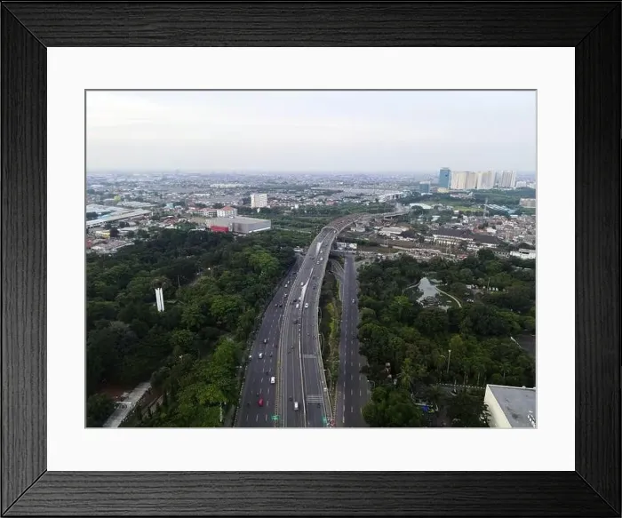 Framed Print : Aerial view of highways and buildings when sunset and noise cloud. Bekasi, Indonesia, March 21, 2021 Framed Print : Aerial view of highways and buildings when sunset and noise cloud. Bekasi, Indonesia, March 21, 2021