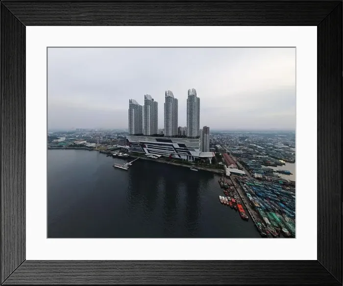 Framed Print : Aerial drone view of Muara Angke Beach with wooden boats leaning beside the pier Framed Print : Aerial drone view of Muara Angke Beach with wooden boats leaning beside the pier