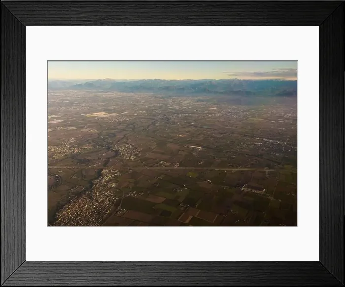 Framed Print : Drone view of rough mounts against building roofs between roadways at sunrise in Dolomites Italy Framed Print : Drone view of rough mounts against building roofs between roadways at sunrise in Dolomites Italy