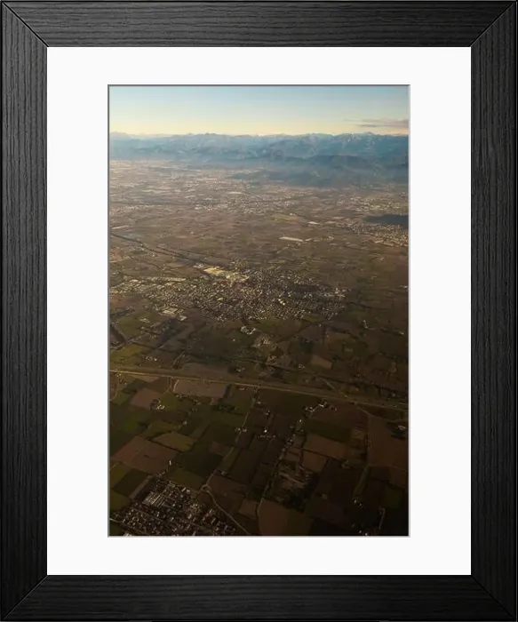Framed Print : Drone view of rough mounts against building roofs between roadways at sunrise in Dolomites Italy Framed Print : Drone view of rough mounts against building roofs between roadways at sunrise in Dolomites Italy