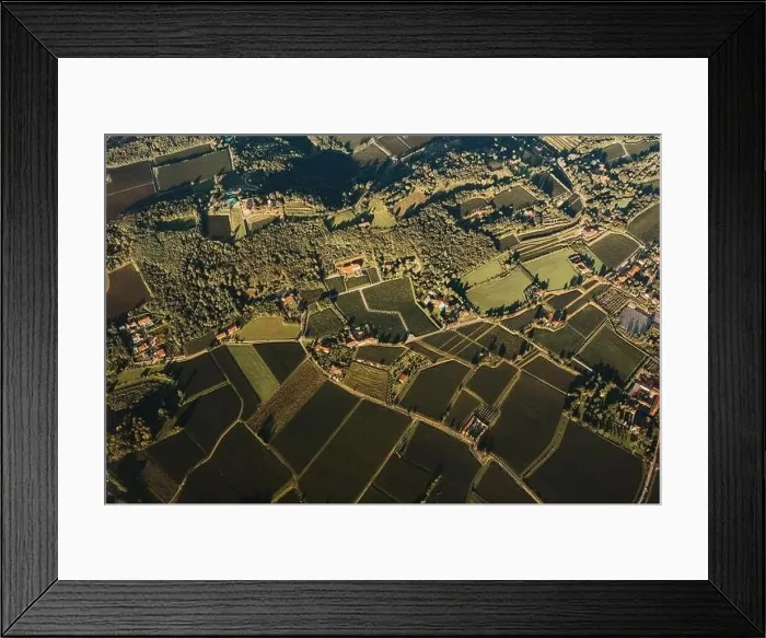 Framed Print : Drone view of rough mounts against building roofs between roadways at sunrise in Dolomites Italy Framed Print : Drone view of rough mounts against building roofs between roadways at sunrise in Dolomites Italy