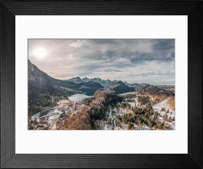 Framed Print : Aerial drone shot of Hohenschwangau by lake in Fussen with view of Alps snow mountain range in Germany winter