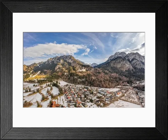 Framed Print : Aerial drone shot of picturesque Neuschwanstein Castle on snowy hill in winter sunlight in Germany Framed Print : Aerial drone shot of picturesque Neuschwanstein Castle on snowy hill in winter sunlight in Germany