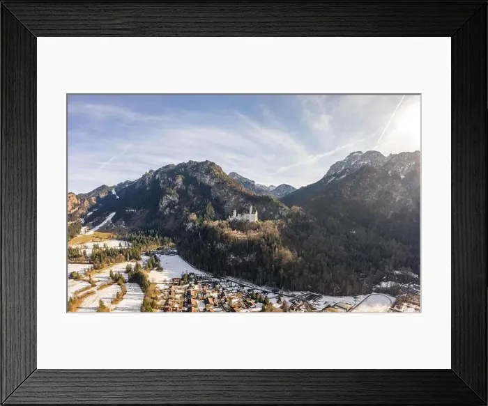 Framed Print : Aerial drone shot of picturesque Neuschwanstein Castle on snowy hill in winter sunlight in Germany Framed Print : Aerial drone shot of picturesque Neuschwanstein Castle on snowy hill in winter sunlight in Germany