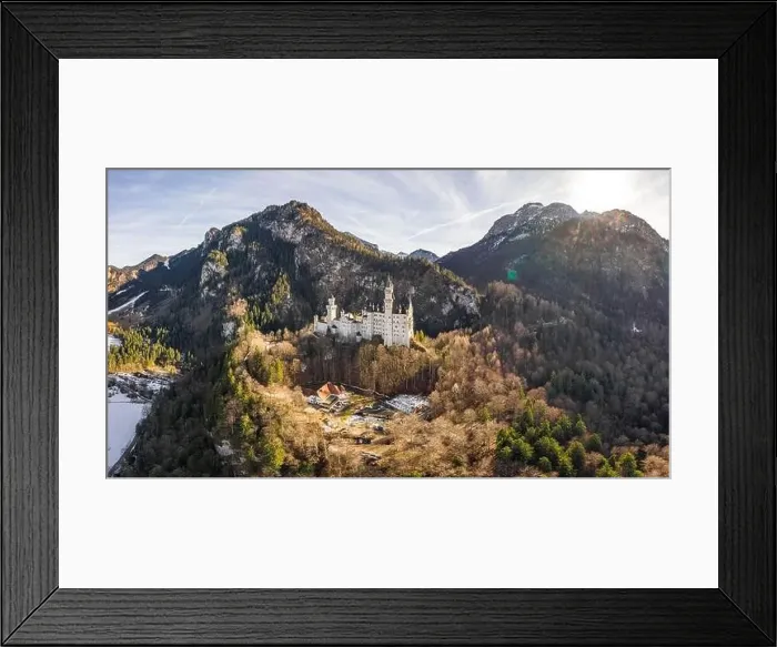 Framed Print : Aerial panorama drone shot of picturesque Neuschwanstein Castle on snowy hill in winter sunlight in Germany Framed Print : Aerial panorama drone shot of picturesque Neuschwanstein Castle on snowy hill in winter sunlight in Germany