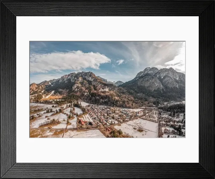 Framed Print : Aerial drone shot of picturesque Neuschwanstein Castle on snowy hill in winter sunlight in Germany Framed Print : Aerial drone shot of picturesque Neuschwanstein Castle on snowy hill in winter sunlight in Germany