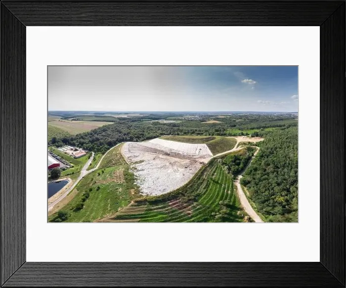 Framed Print : Garbage trucks unload garbage to a landfill Framed Print : Garbage trucks unload garbage to a landfill