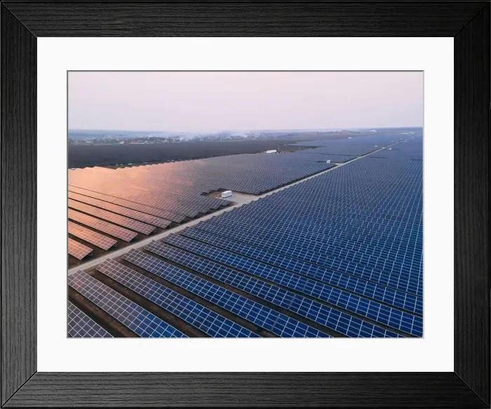 Framed Print : Aerial drone view of large solar panels at a solar farm at bright spring windy sunset Framed Print : Aerial drone view of large solar panels at a solar farm at bright spring windy sunset