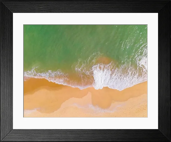 Framed Print : Aerial view of a beach and waves along the sea Framed Print : Aerial view of a beach and waves along the sea