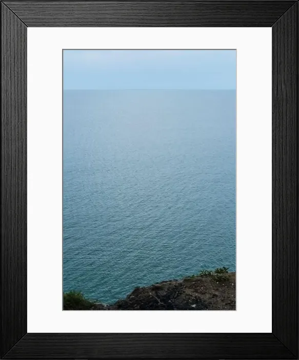 Framed Print : Top view from the cliff to the vast expanses of the blue sea in cloudy weather. Beautiful seascape from a drone Framed Print : Top view from the cliff to the vast expanses of the blue sea in cloudy weather. Beautiful seascape from a drone