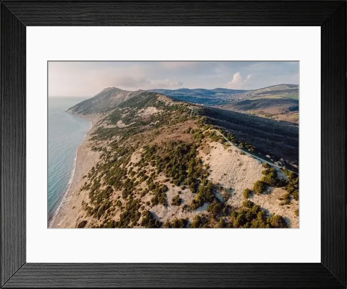 Framed Print : Aerial view of coastline with sea and cliff with evergreen trees Framed Print : Aerial view of coastline with sea and cliff with evergreen trees