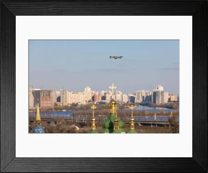 Framed Print : Drone flies over Vydubychi Monastery in Kyiv. Domes of the Christian monastery. Focus on drone with blurred background Framed Print : Drone flies over Vydubychi Monastery in Kyiv. Domes of the Christian monastery. Focus on drone with blurred background