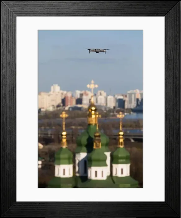 Framed Print : Drone flies over Vydubychi Monastery in Kyiv. Domes of the Christian monastery. Focus on drone with blurred background Framed Print : Drone flies over Vydubychi Monastery in Kyiv. Domes of the Christian monastery. Focus on drone with blurred background