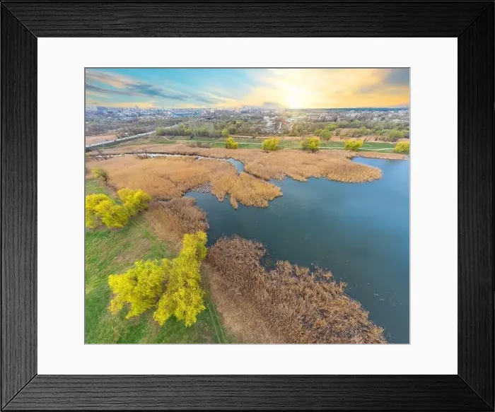 Framed Print : View of the river and the green bank from a height at sunset. Photo from a quadcopter Framed Print : View of the river and the green bank from a height at sunset. Photo from a quadcopter