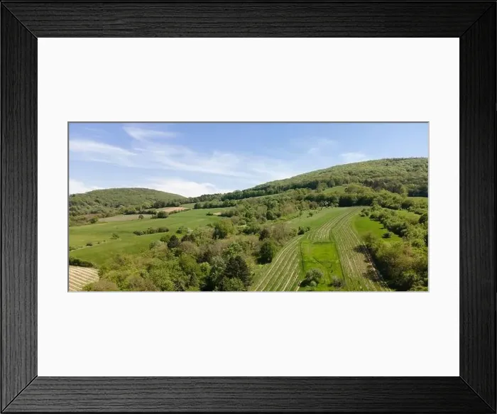 Framed Print : aerial drone flight photo of green hills, meadows and fresh forest in Lower Austria at the edge of Vienna Woods Framed Print : aerial drone flight photo of green hills, meadows and fresh forest in Lower Austria at the edge of Vienna Woods