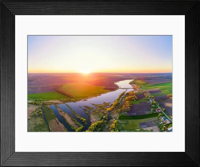 Framed Print : Aerial photo of sunset countryside landscape with lake, green fields and village Framed Print : Aerial photo of sunset countryside landscape with lake, green fields and village