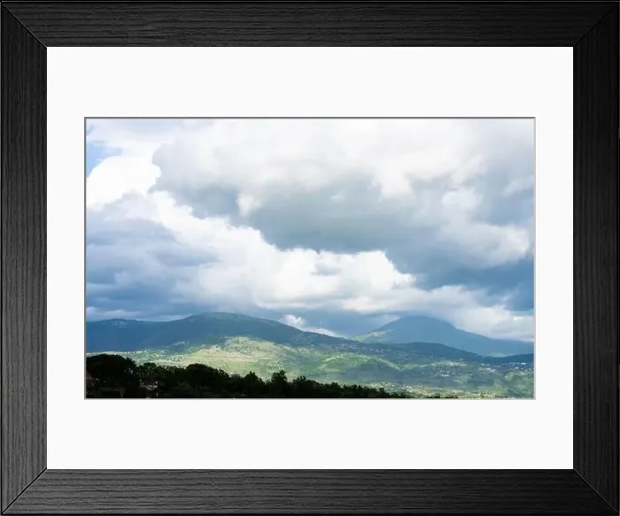 Framed Print : Stunning landscape with green hills and mountains during a cloudy day Framed Print : Stunning landscape with green hills and mountains during a cloudy day