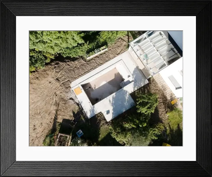 Framed Print : Drone shot of pool construction site in a garden, earth around the pool is already backfilled Framed Print : Drone shot of pool construction site in a garden, earth around the pool is already backfilled