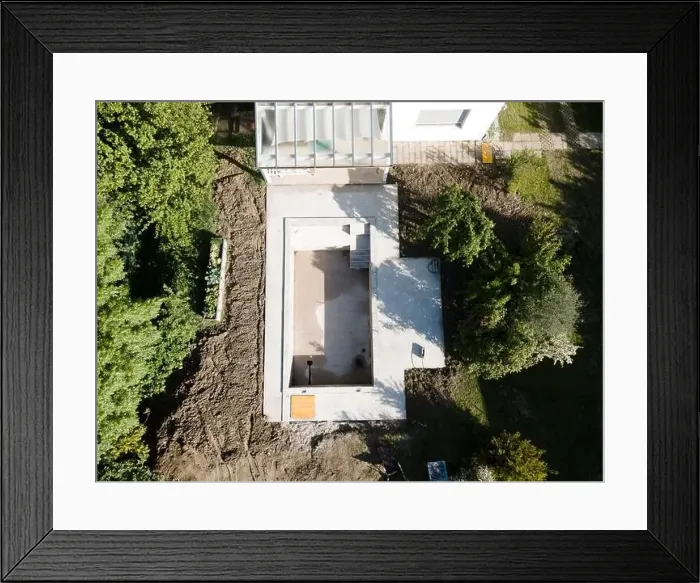 Framed Print : Drone shot of pool construction site in a garden, earth around the pool is already backfilled Framed Print : Drone shot of pool construction site in a garden, earth around the pool is already backfilled