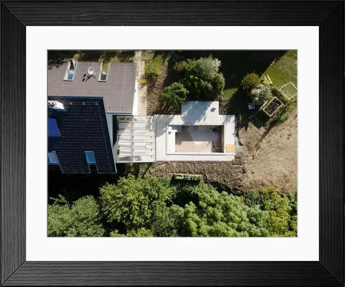Framed Print : Drone shot of pool construction site in a garden, earth around the pool is already backfilled