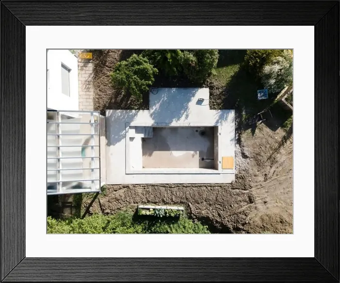 Framed Print : Drone shot of pool construction site in a garden, earth around the pool is already backfilled