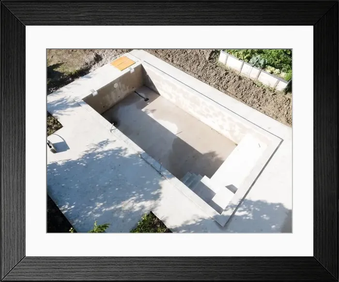 Framed Print : Drone shot of pool construction site in a garden, earth around the pool is already backfilled