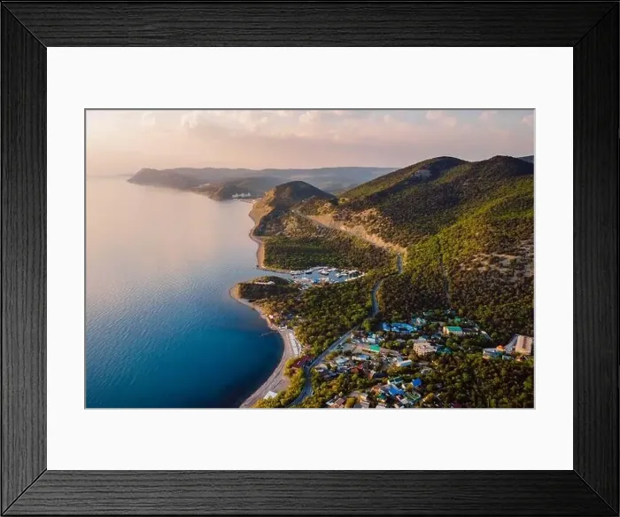 Framed Print : Aerial view of coastline with blue sea, mountains with trees, cliffs with sunset light Framed Print : Aerial view of coastline with blue sea, mountains with trees, cliffs with sunset light