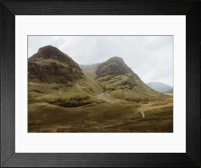 Framed Print : Dirt path on rough grassy hillside in Glencoe, UK countryside on cloudy day Framed Print : Dirt path on rough grassy hillside in Glencoe, UK countryside on cloudy day