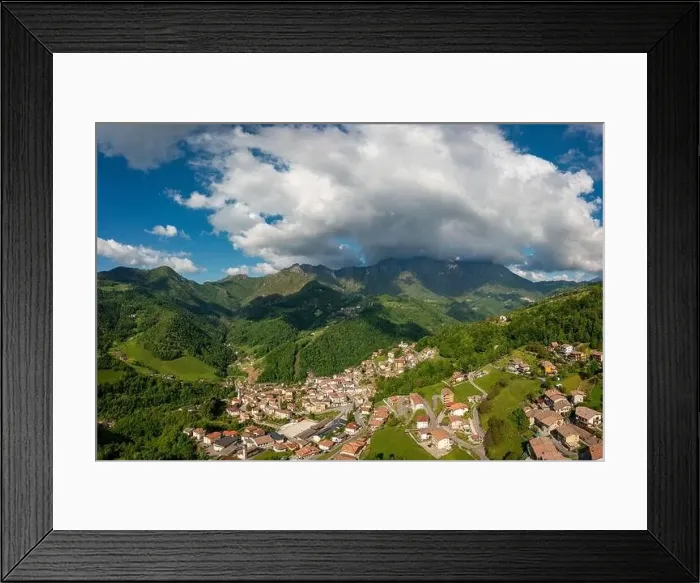 Framed Print : Drone aerial view to the Seriana valley and Orobie Alps with big cloud and blue sky Framed Print : Drone aerial view to the Seriana valley and Orobie Alps with big cloud and blue sky