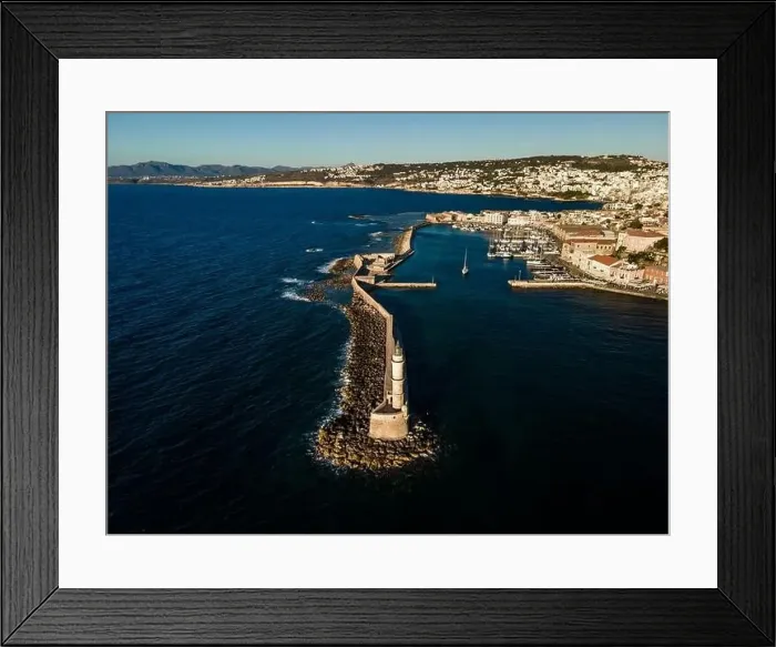 Framed Print : Aerial top view by drone of iconic Venetian lighthouse in the entrance of picturesque old port of Chania at sunset