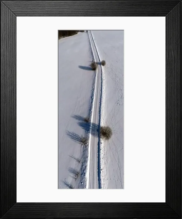 Framed Print : Winter rural gravel road in snow, vertical pano, aerial view Framed Print : Winter rural gravel road in snow, vertical pano, aerial view