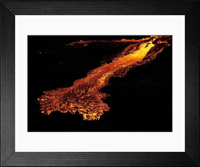 Framed Print : Drone view of stream of hot orange lava flowing through mountainous terrain in morning in Iceland Framed Print : Drone view of stream of hot orange lava flowing through mountainous terrain in morning in Iceland
