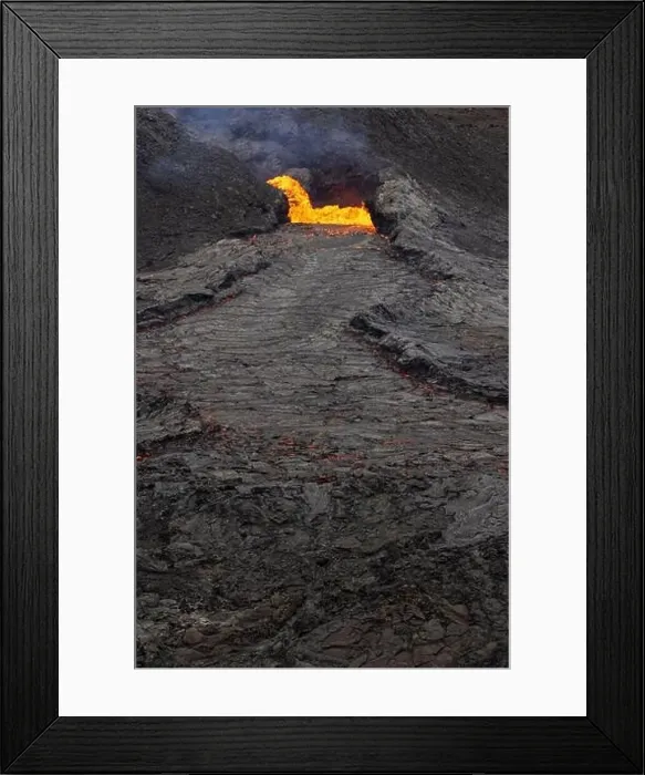 Framed Print : Drone view of stream of hot orange lava flowing through mountainous terrain in morning in Iceland Framed Print : Drone view of stream of hot orange lava flowing through mountainous terrain in morning in Iceland