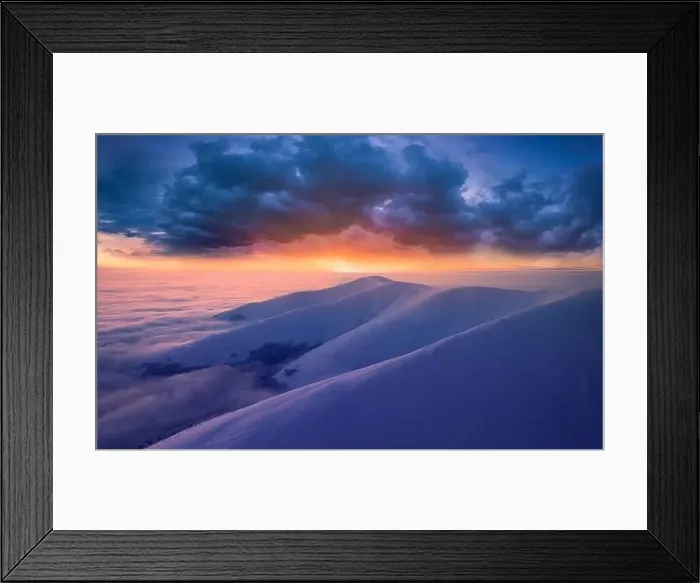 Framed Print : Dawn over the tops of snow-capped mountains view from a drone Framed Print : Dawn over the tops of snow-capped mountains view from a drone