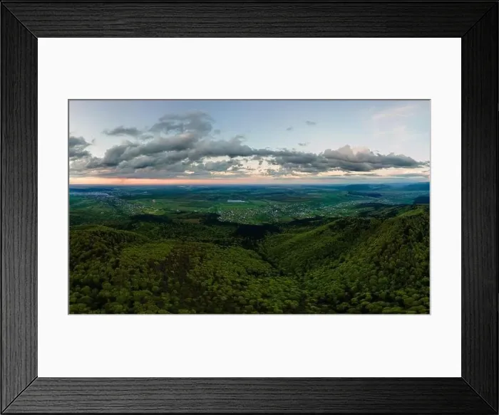 Framed Print : Aerial wide panoramic view of dark mountain hills covered with green mixed pine and lush forest in evening Framed Print : Aerial wide panoramic view of dark mountain hills covered with green mixed pine and lush forest in evening