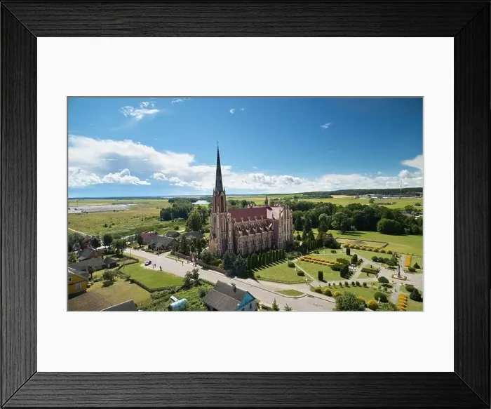 Framed Print : Red catholic church on blue sky background aerial view