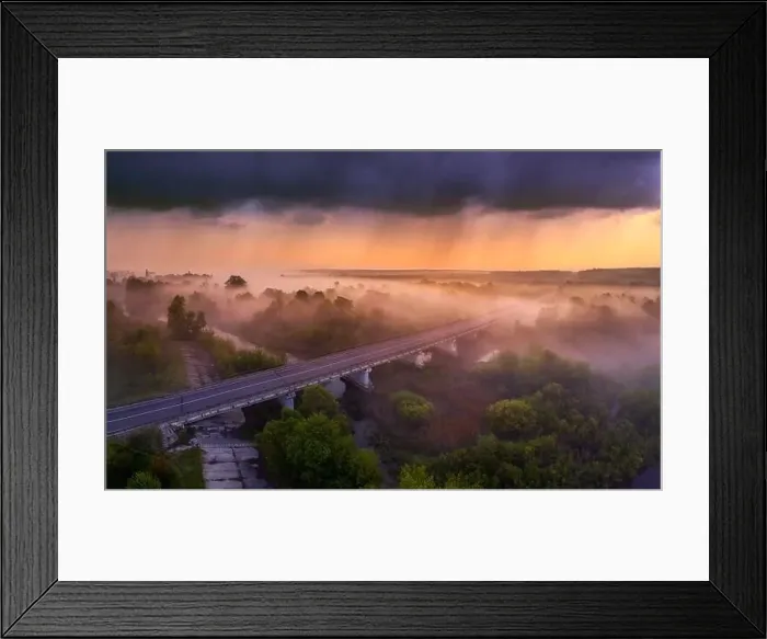 Framed Print : Drone view of the bright dawn over the highway overpass, forest and misty meadow