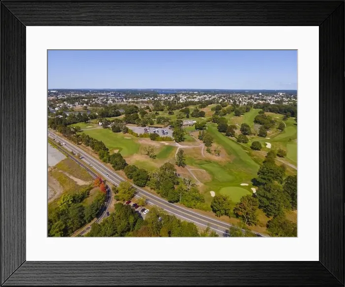Framed Print : Aerial view of a golf course and Veterans Memorial Pkwy with historic city at the background in East Providence Framed Print : Aerial view of a golf course and Veterans Memorial Pkwy with historic city at the background in East Providence