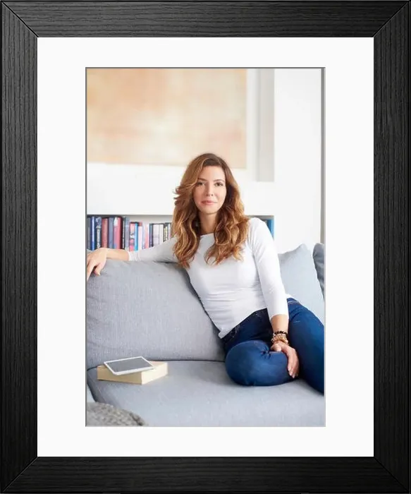 Framed Print : Shot of a smiling mature woman napping on a sofa in her modern cosy home