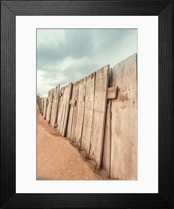 Framed Print : Worn wooden fence on sandy beach, vertical image selective focus Framed Print : Worn wooden fence on sandy beach, vertical image selective focus