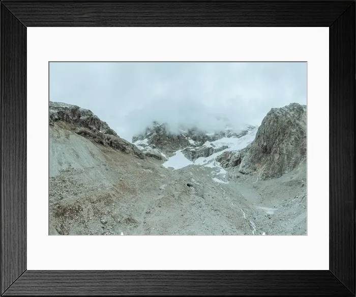 Framed Print : drone view over a desolate receding alpine glacier surrounded by mountains and snow covered rocks and peaks Framed Print : drone view over a desolate receding alpine glacier surrounded by mountains and snow covered rocks and peaks