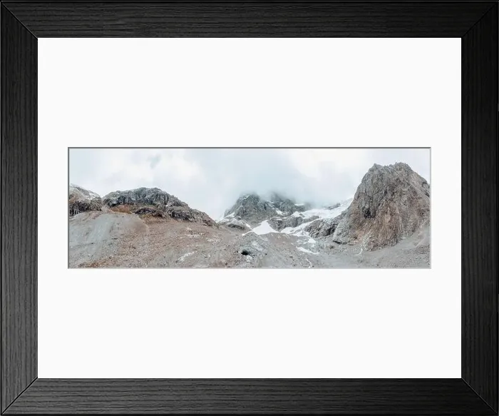 Framed Print : drone view over a desolate receding alpine glacier surrounded by mountains and snow covered rocks and peaks Framed Print : drone view over a desolate receding alpine glacier surrounded by mountains and snow covered rocks and peaks