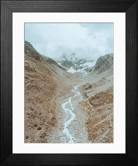Framed Print : drone view over a desolate receding alpine glacier surrounded by mountains and snow covered rocks and peaks Framed Print : drone view over a desolate receding alpine glacier surrounded by mountains and snow covered rocks and peaks